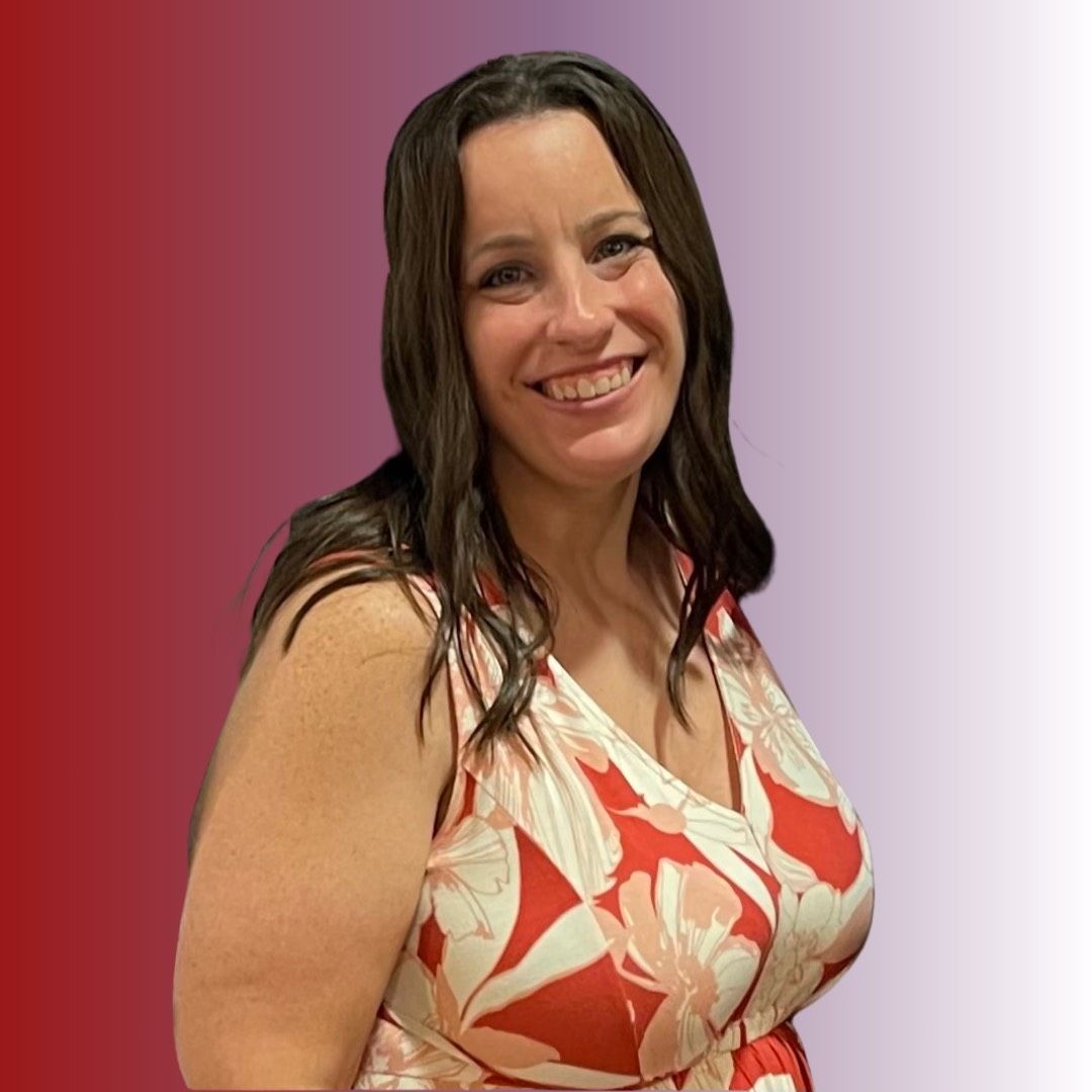 Smiling woman in a red and white floral dress with long brown hair against a gradient background.